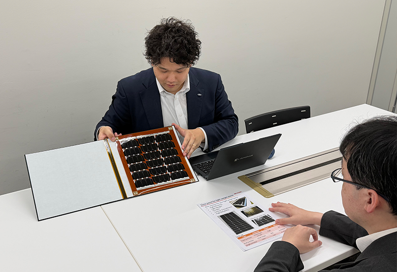 宇宙用太陽電池のサンプルを用いて客先商談をしています